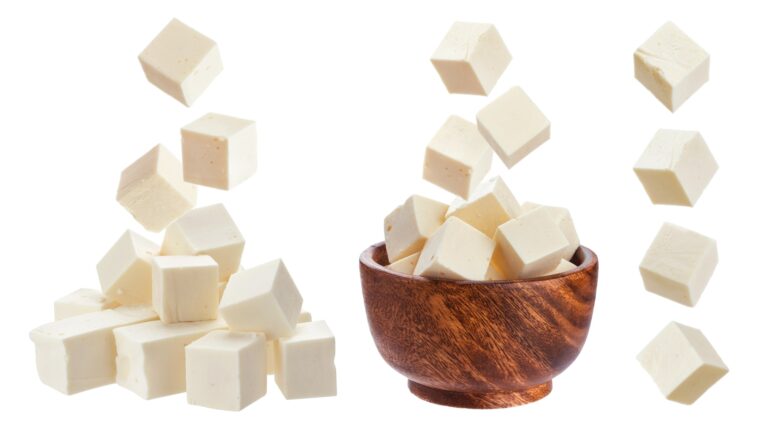 Feta isolated. Falling pieces of white cheese